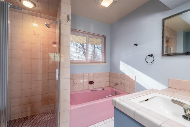 bathroom featuring tile patterned floors, vanity, and separate shower and tub