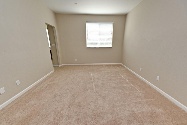 unfurnished room with light carpet