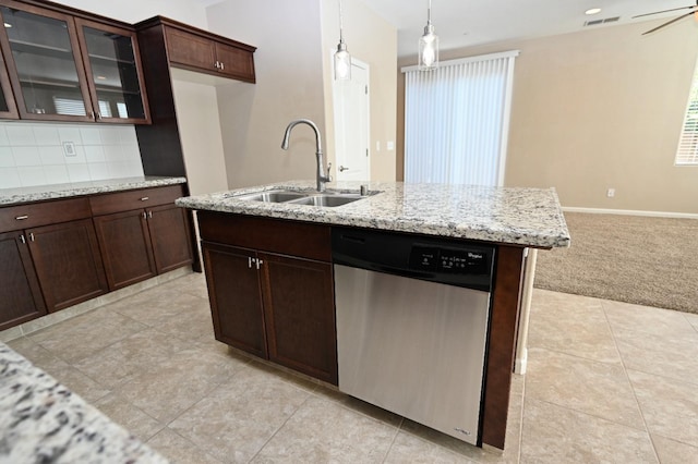 kitchen with light carpet, light stone countertops, pendant lighting, stainless steel dishwasher, and sink