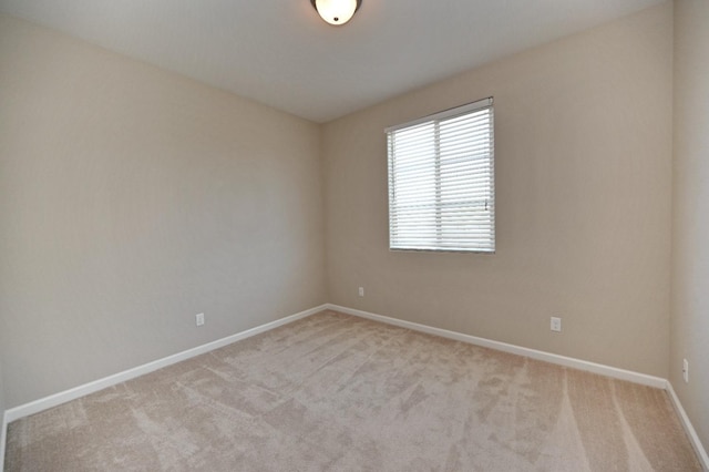 unfurnished room with light carpet