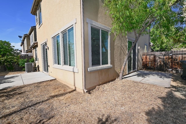 view of home's exterior with central AC and a patio