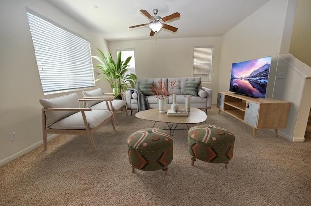 carpeted living room with ceiling fan