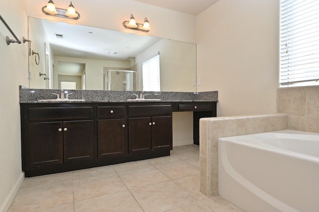 bathroom with vanity, independent shower and bath, and tile patterned flooring