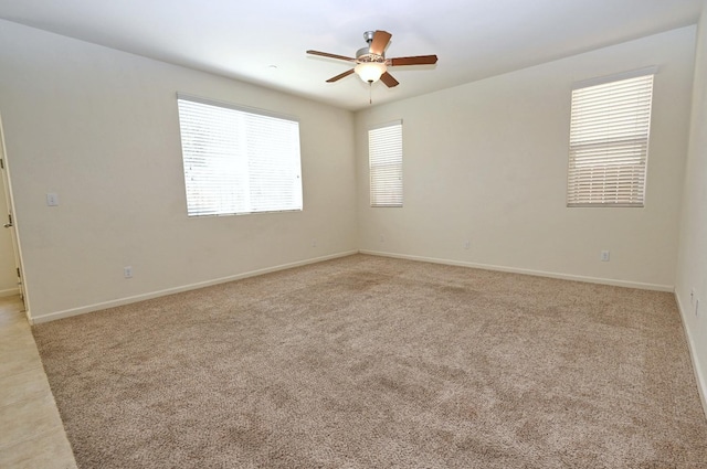 carpeted spare room with ceiling fan