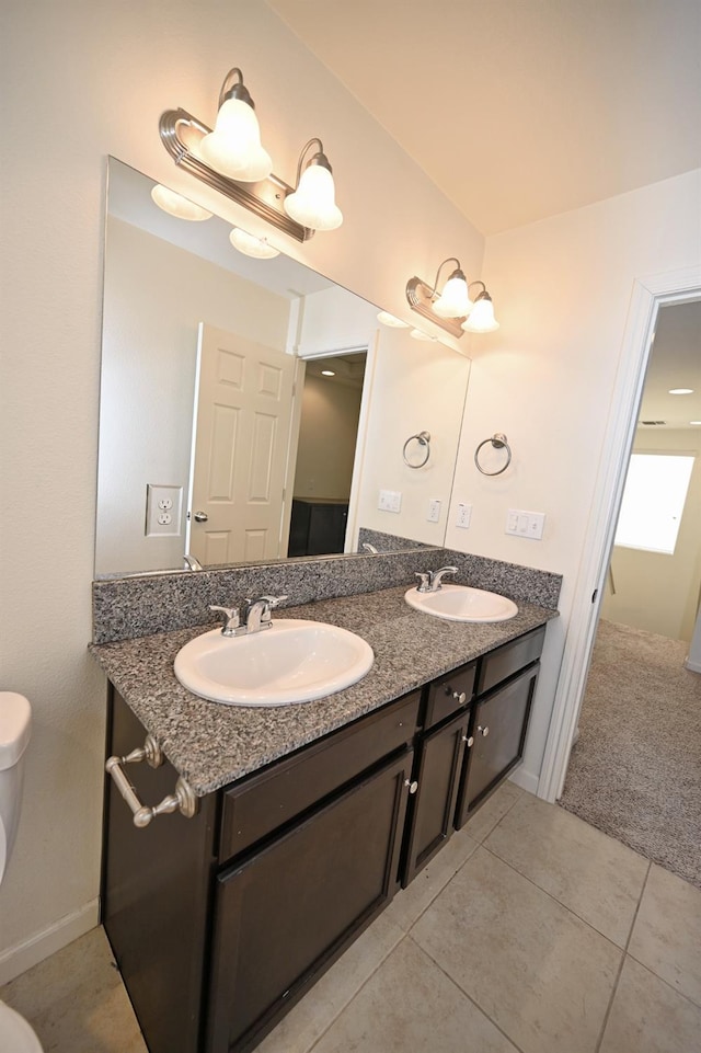 bathroom with tile patterned floors, vanity, and toilet