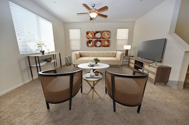 carpeted living room featuring ceiling fan