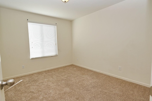 unfurnished room featuring light colored carpet