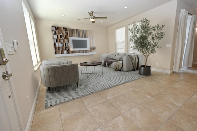 living room featuring ceiling fan, plenty of natural light, and light tile patterned floors