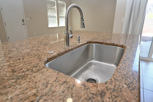 room details featuring sink and stone counters