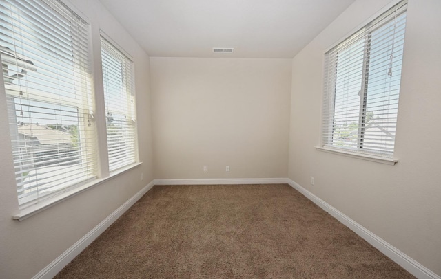 carpeted empty room featuring a healthy amount of sunlight