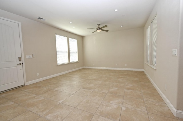 empty room featuring ceiling fan and light tile patterned floors