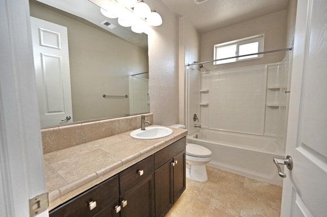 full bathroom with a textured ceiling, washtub / shower combination, vanity, and toilet