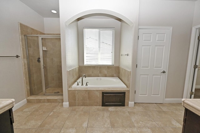 bathroom featuring plus walk in shower and vanity