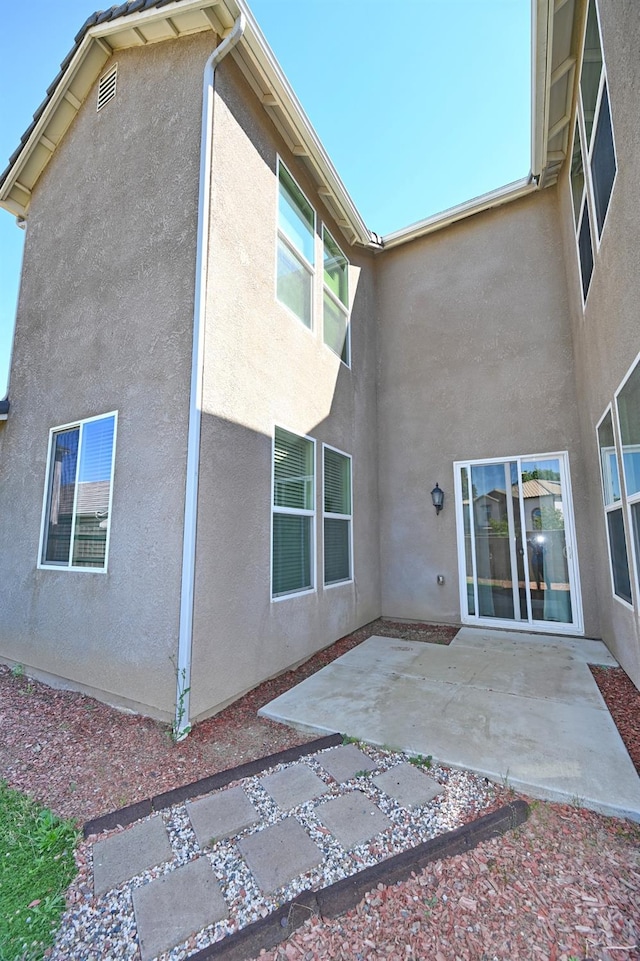 back of property with a patio area