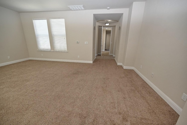 unfurnished room featuring light colored carpet