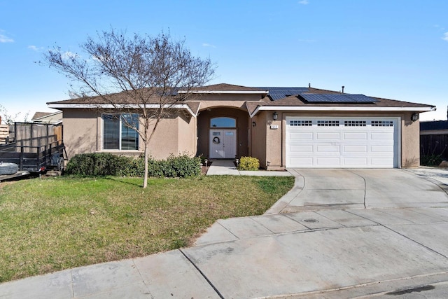 ranch-style house with a front lawn, solar panels, and a garage