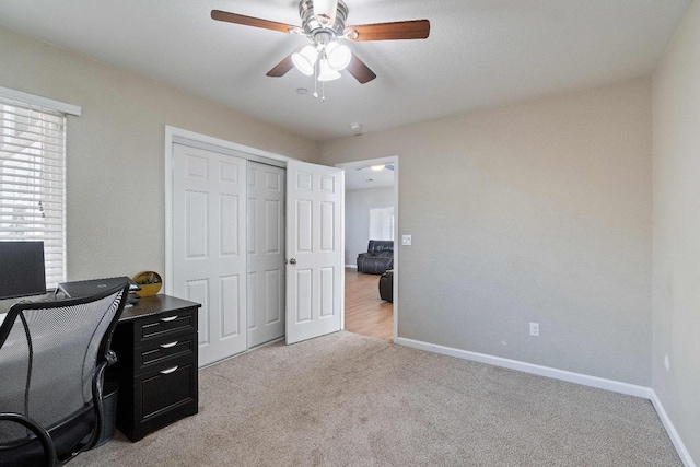 office area featuring ceiling fan and light colored carpet