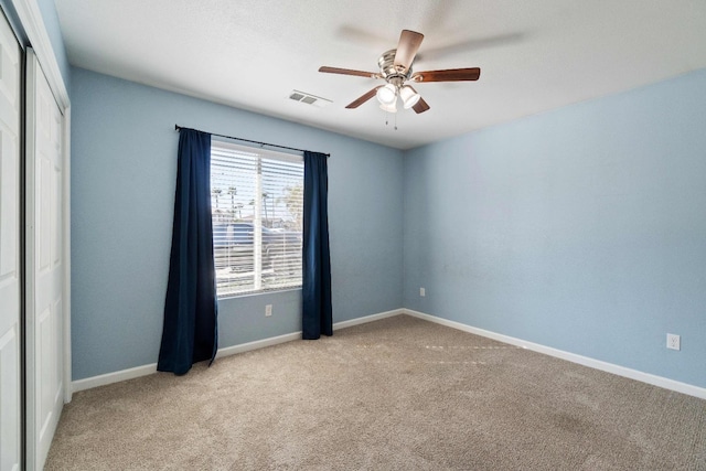 unfurnished room with ceiling fan and light colored carpet