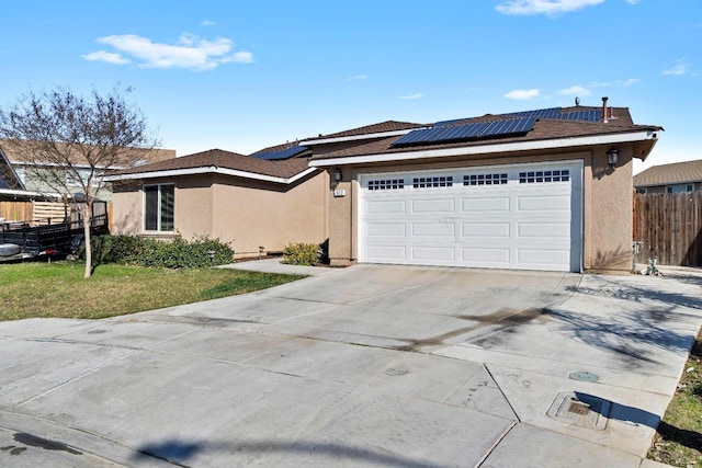 view of front of property with a garage and solar panels