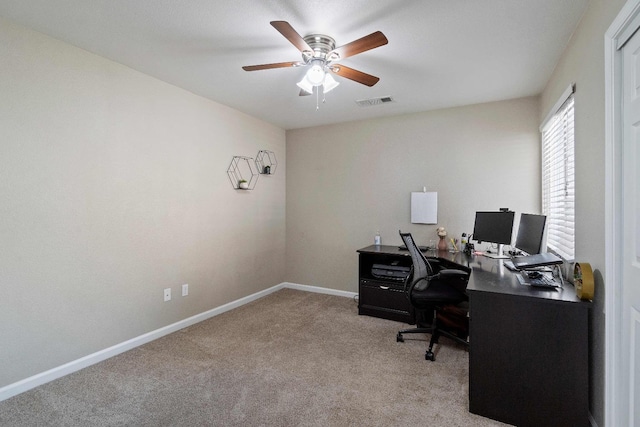 office with light carpet and ceiling fan