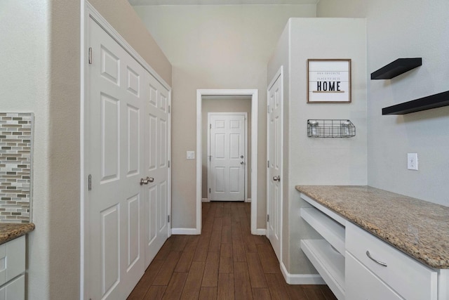 hallway featuring dark hardwood / wood-style flooring