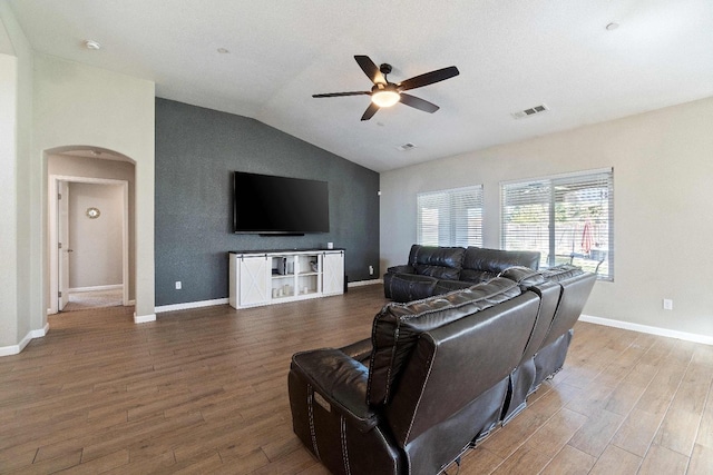 living room featuring lofted ceiling, wood-type flooring, and ceiling fan