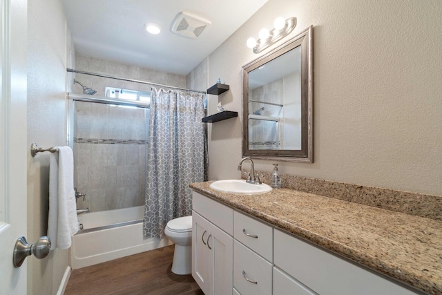 full bathroom featuring toilet, hardwood / wood-style flooring, vanity, and shower / tub combo with curtain