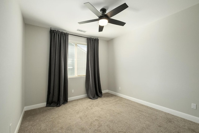 empty room featuring light carpet and ceiling fan