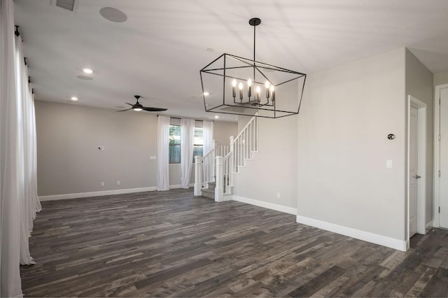 interior space with dark wood-type flooring and ceiling fan with notable chandelier