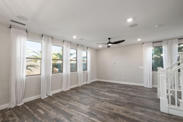 unfurnished room featuring ceiling fan and dark wood-type flooring