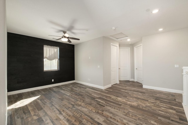 spare room with ceiling fan and dark hardwood / wood-style floors