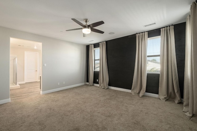 unfurnished room featuring ceiling fan and light carpet