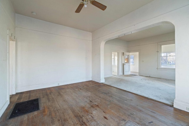 empty room with ceiling fan and wood-type flooring