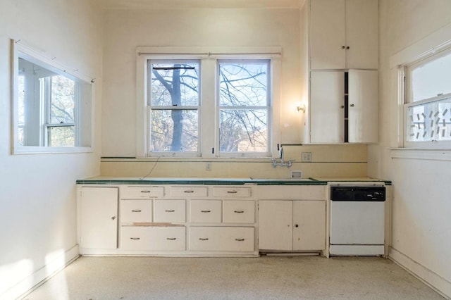 kitchen with white cabinetry, white dishwasher, and sink