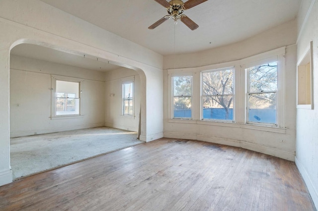 empty room featuring ceiling fan and light wood-type flooring