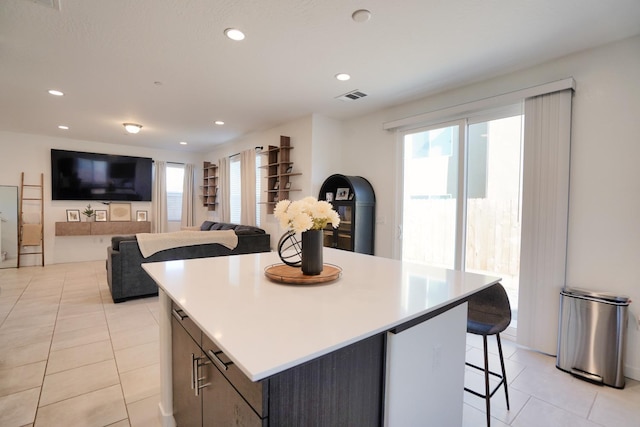 kitchen featuring a healthy amount of sunlight, recessed lighting, visible vents, and a center island