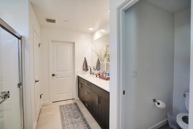 full bathroom with toilet, a sink, tile patterned floors, double vanity, and a stall shower