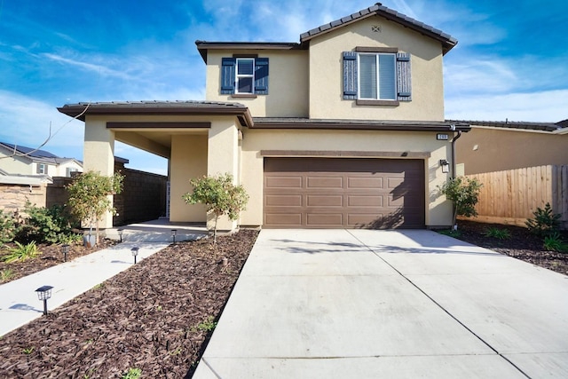 view of front of property with a garage, fence, driveway, a tiled roof, and stucco siding