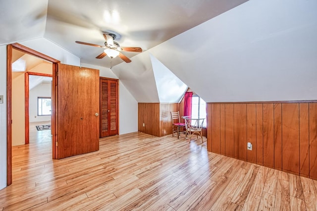 additional living space with ceiling fan, lofted ceiling, and light hardwood / wood-style floors