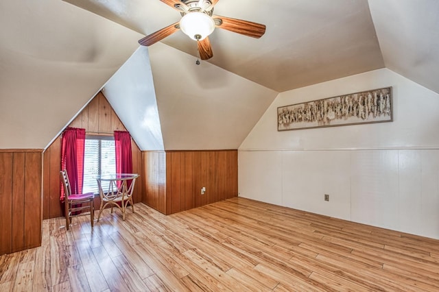 additional living space featuring ceiling fan, lofted ceiling, and light hardwood / wood-style floors