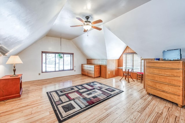 additional living space featuring ceiling fan, light wood-type flooring, and lofted ceiling