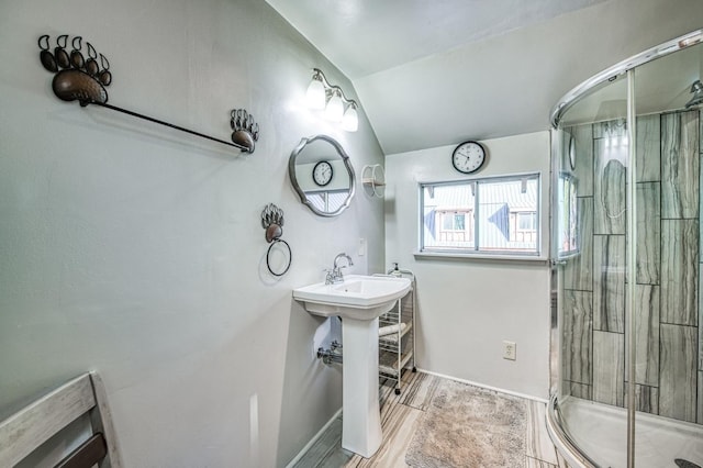 bathroom featuring walk in shower and lofted ceiling