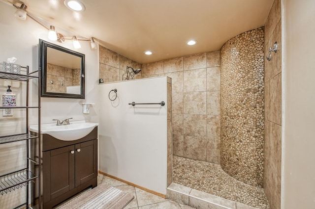 bathroom with vanity, tile patterned floors, and tiled shower