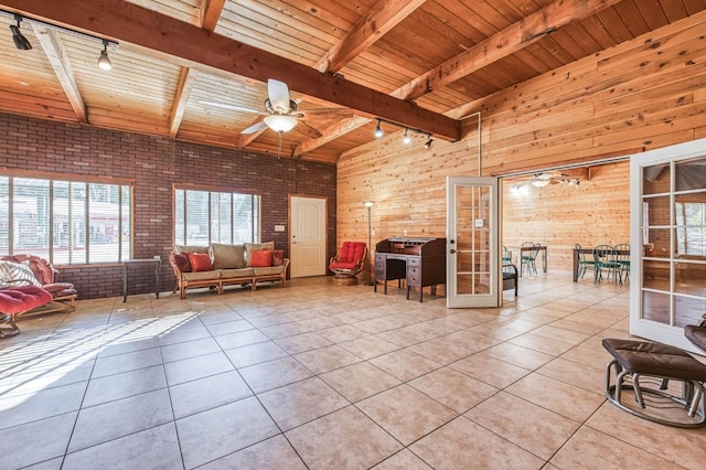 tiled living room with brick wall, wood ceiling, french doors, wooden walls, and rail lighting