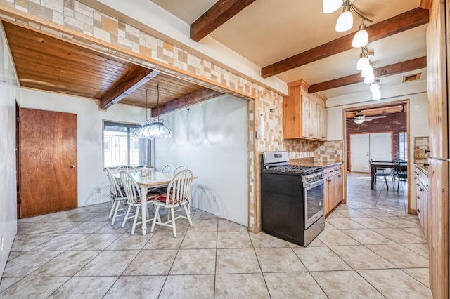 kitchen featuring stainless steel gas range, wood ceiling, light brown cabinetry, ceiling fan, and light tile patterned floors