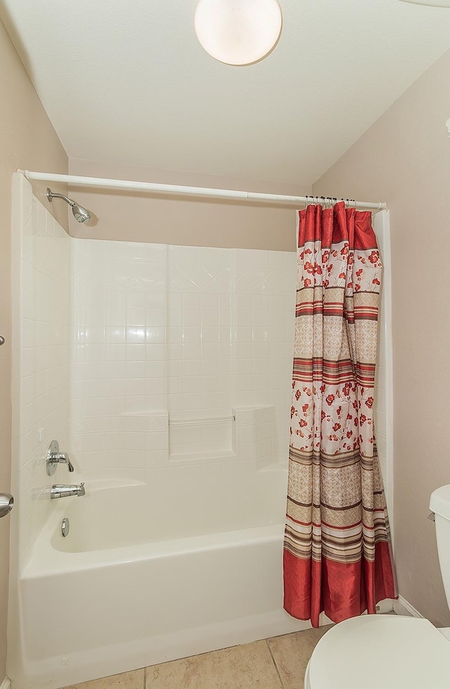 full bath with shower / bath combo, toilet, and tile patterned floors