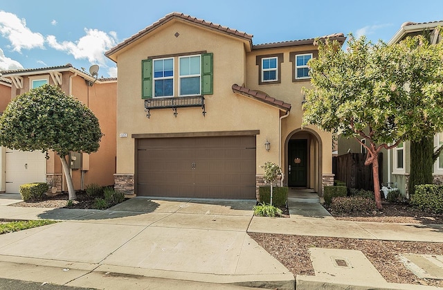 mediterranean / spanish-style house featuring a garage, a tile roof, stone siding, driveway, and stucco siding