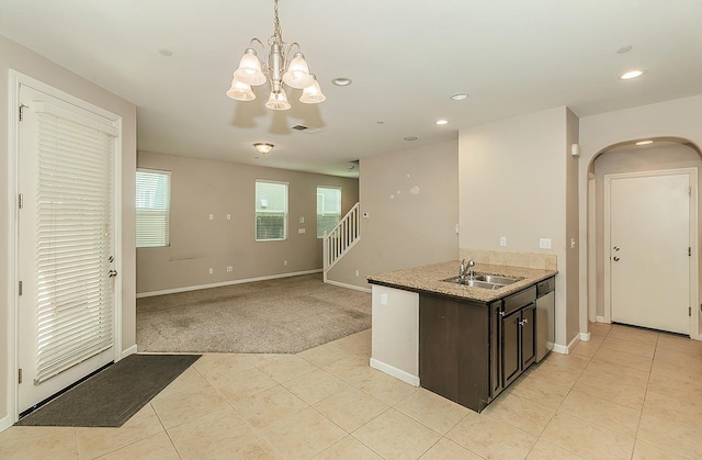 kitchen with visible vents, dishwasher, light colored carpet, decorative light fixtures, and a sink