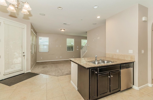 kitchen featuring light tile patterned floors, a sink, visible vents, baseboards, and stainless steel dishwasher