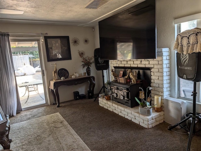 carpeted living room featuring a textured ceiling